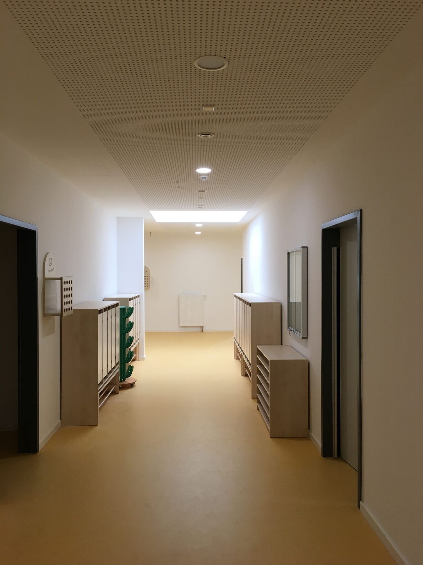 Flur eines Lernhauses mit Garderoben aus Holz